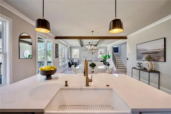 a living room with furniture and a chandelier