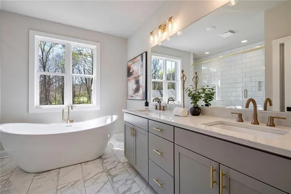 a spacious bathroom with a large tub and sink