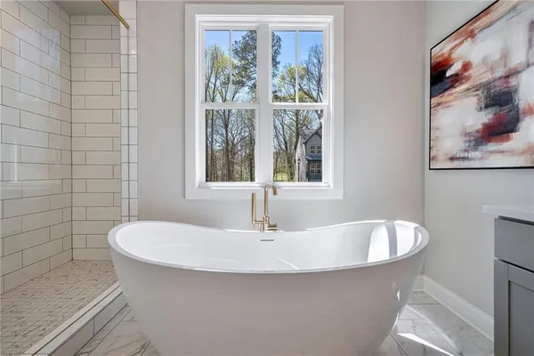 a white bath tub sitting next to a white sink