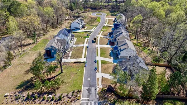 an aerial view of a house with a yard