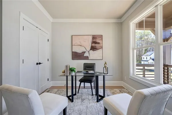 a view of a livingroom with workspace and a window