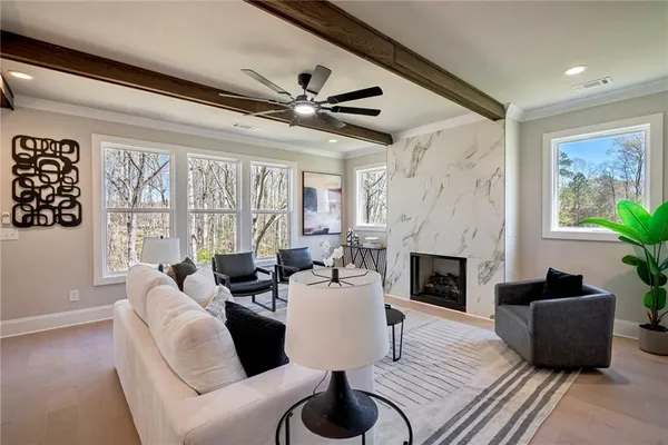 a living room with furniture fireplace and a large window