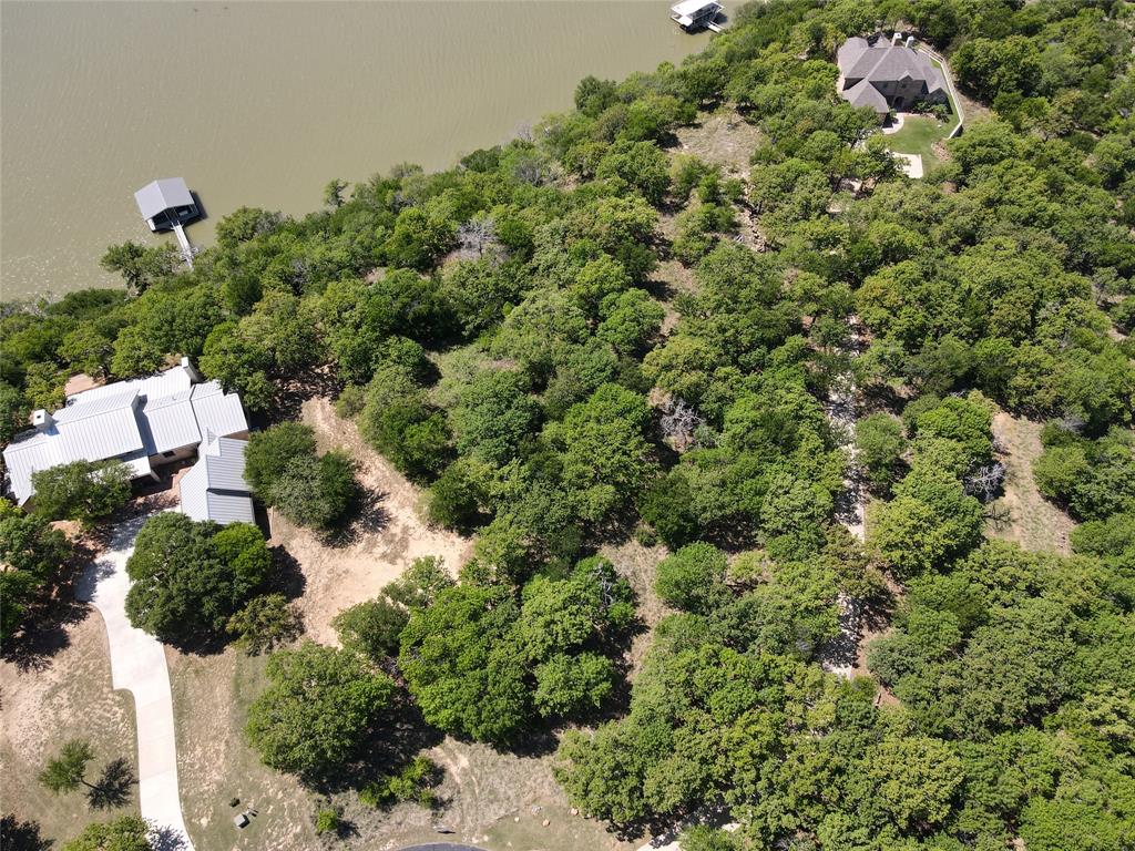 Tbd Ridgeline Drive Chico, TX 76431 - Photo 6 of 14 a view of a house with a small yard and covered with trees