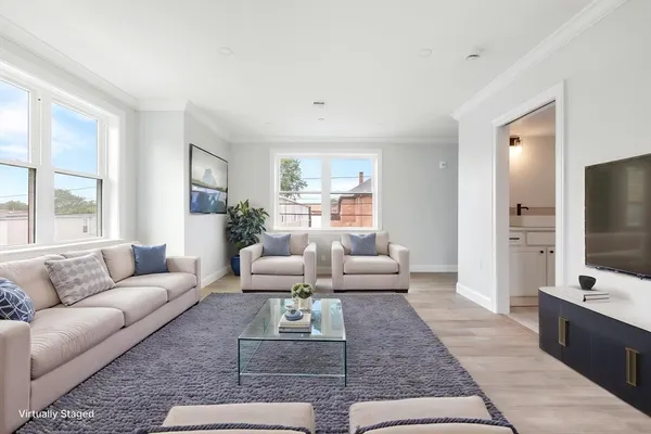 a living room with furniture wooden floor and a flat screen tv
