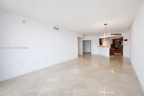 an empty room with a kitchen and a sink
