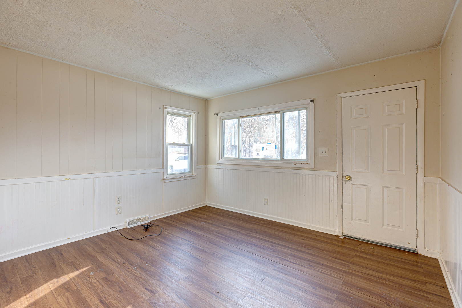326 West Park Road Round Lake, IL 60073 - Photo 2 of 22 an empty room with wooden floor and windows