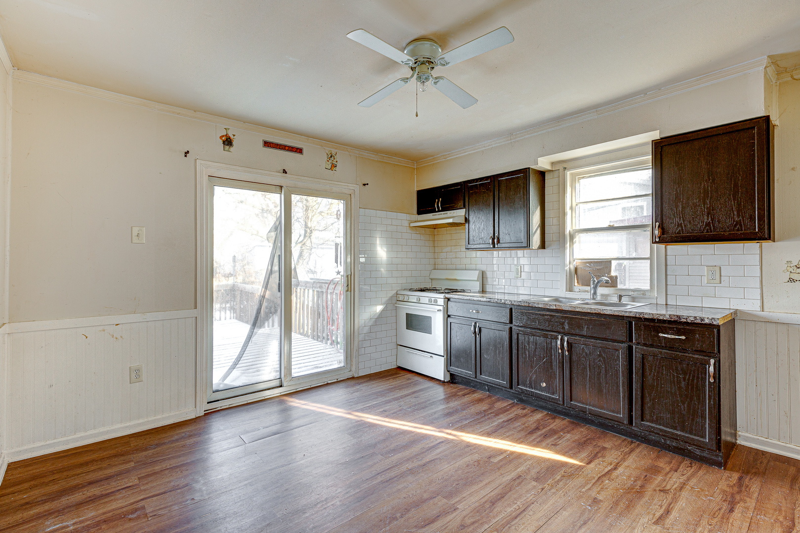 326 West Park Road Round Lake, IL 60073 - Photo 4 of 22 a large kitchen with granite countertop a stove a sink dishwasher a refrigerator and a microwave oven with wooden floor