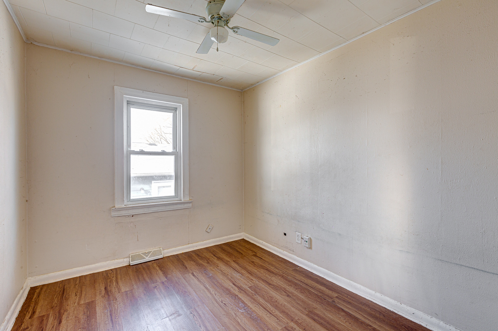 326 West Park Road Round Lake, IL 60073 - Photo 10 of 22 an empty room with a window and wooden floor