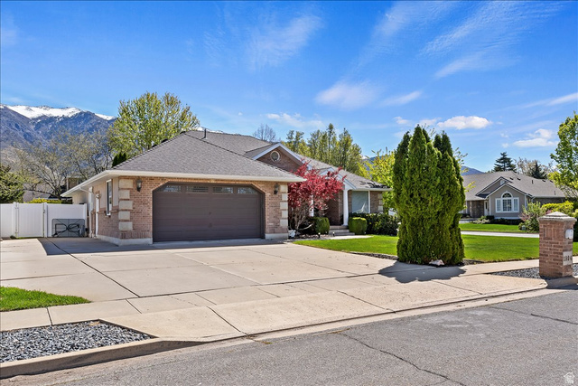 1924 North 2000th Street East Layton, UT 84040 - Photo 4 of 41 Single story home featuring brick siding, a gate, an attached garage, concrete driveway, and a shingled roof
