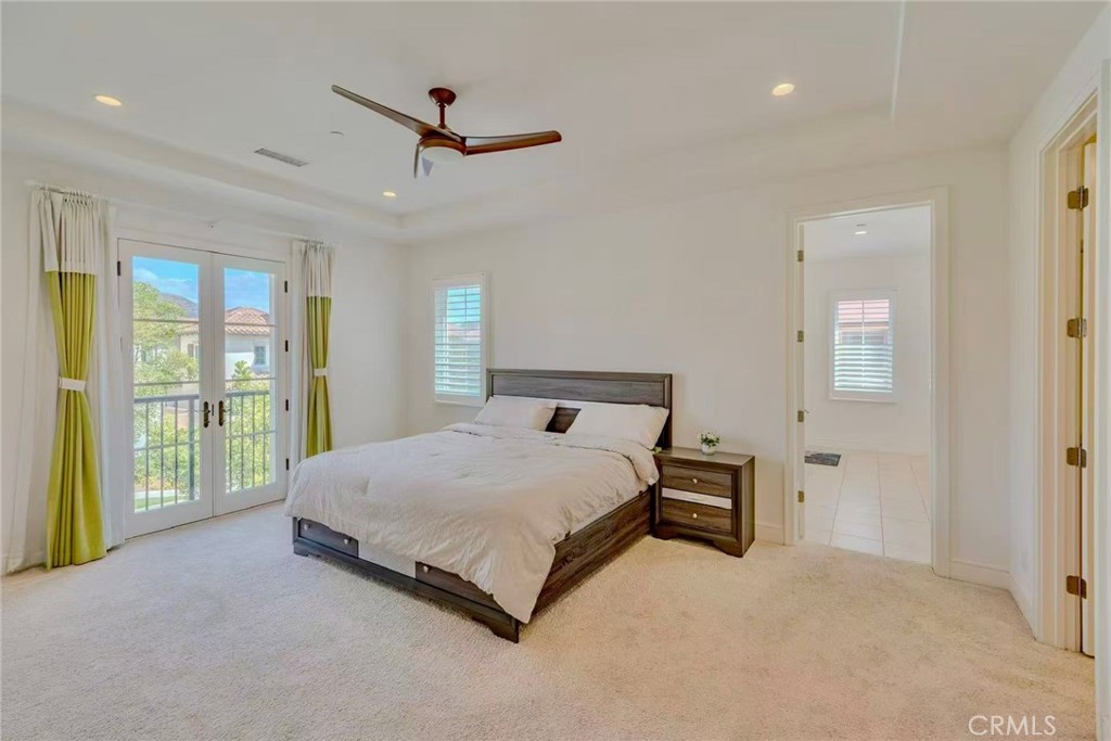 141 Dolci Irvine, CA 92602 - Photo 12 of 13 a bed sitting in a spacious bedroom next to a window