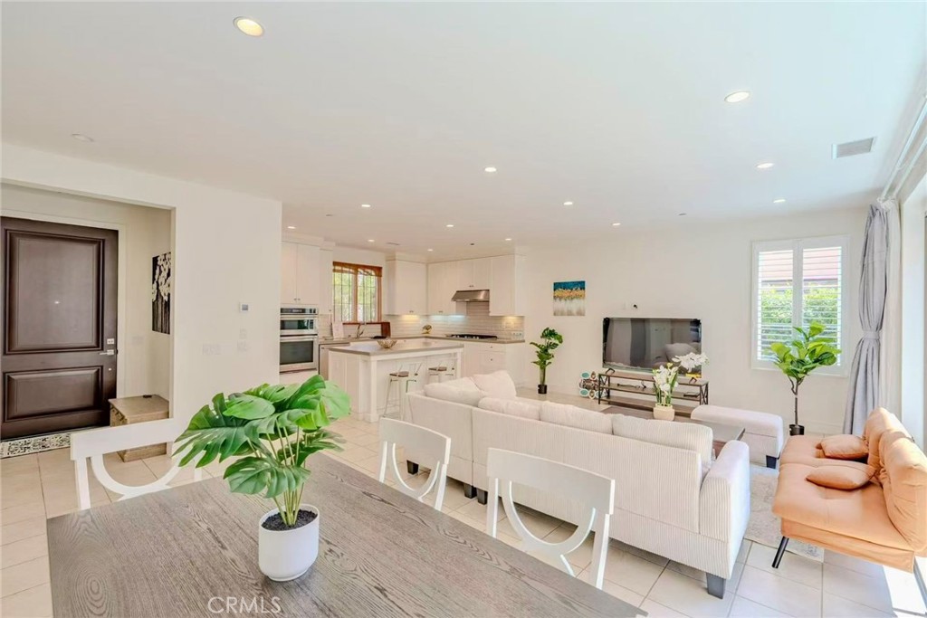 141 Dolci Irvine, CA 92602 - Photo 8 of 13 a living room with furniture potted plant and kitchen view