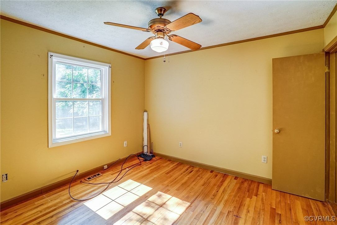 13800 Cross County Road Mineral, VA 23117 - Photo 15 of 47 a view of a bedroom with wooden floor and a window
