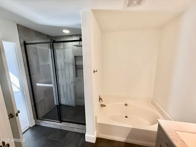 a bathroom with a bathtub and a shower