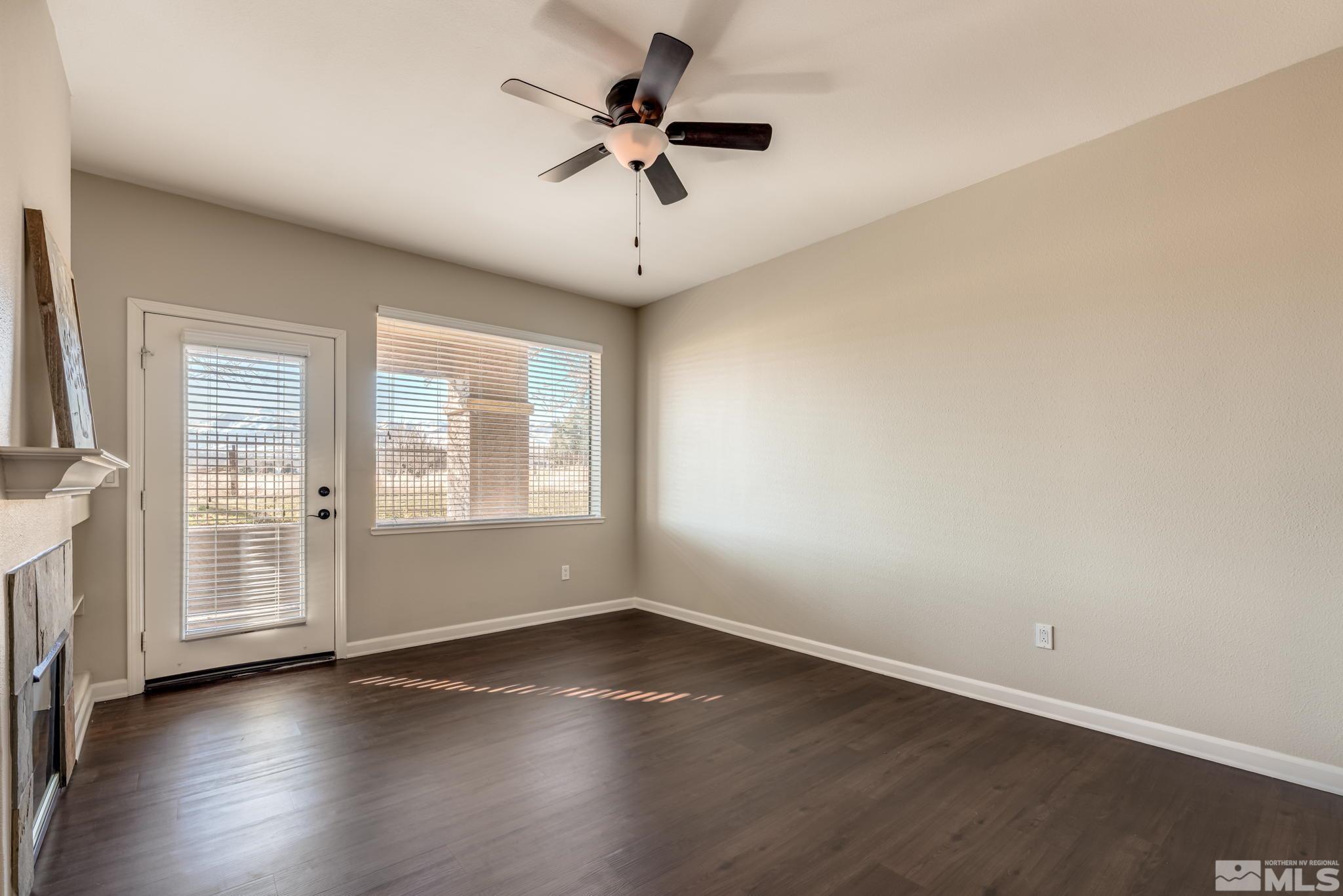 900 S Meadows, Unit 5313 Reno, NV 89521 - Photo 11 of 29 an empty room with wooden floor fan and windows