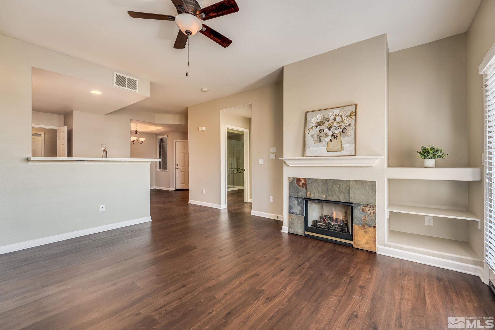 900 S Meadows, Unit 5313 Reno, NV 89521 - Photo 12 of 29 a view of an empty room with wooden floor fireplace and a window