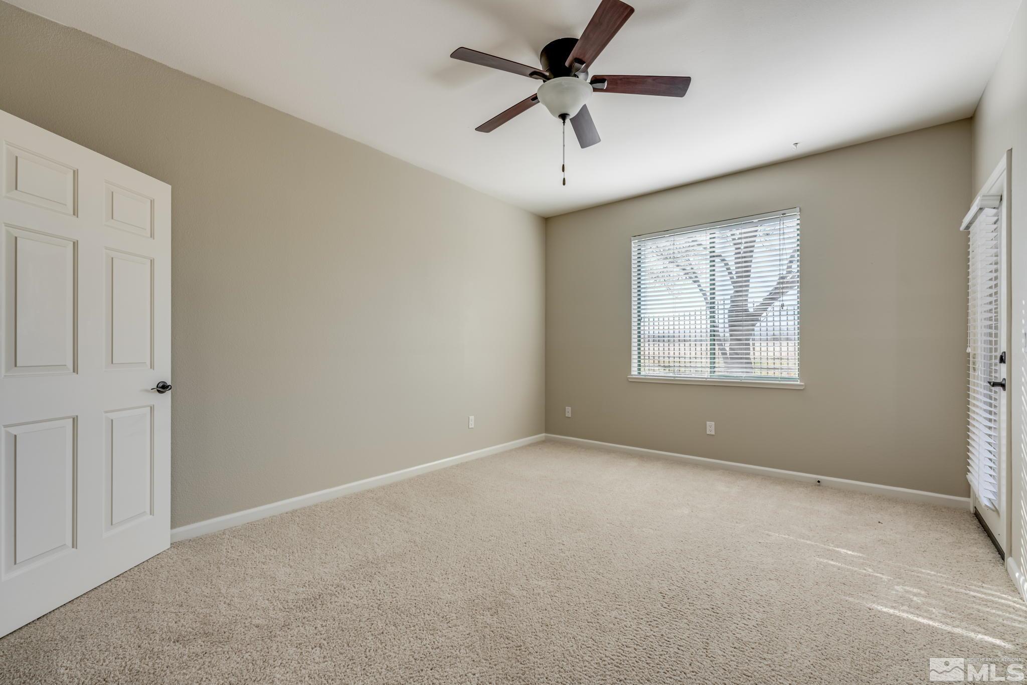 900 S Meadows, Unit 5313 Reno, NV 89521 - Photo 15 of 29 an empty room with windows and ceiling fan