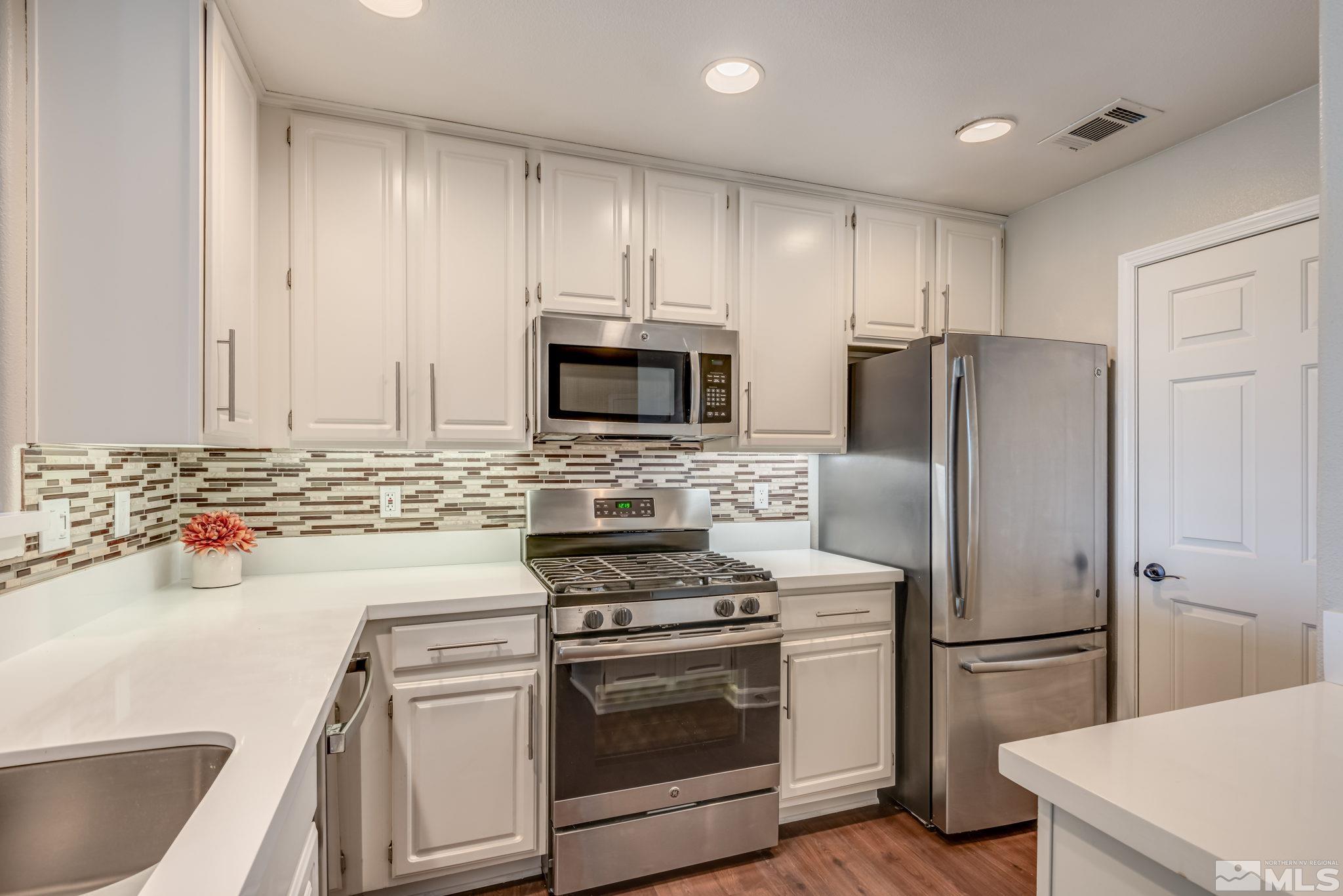 900 S Meadows, Unit 5313 Reno, NV 89521 - Photo 7 of 29 a kitchen with a refrigerator sink and stove