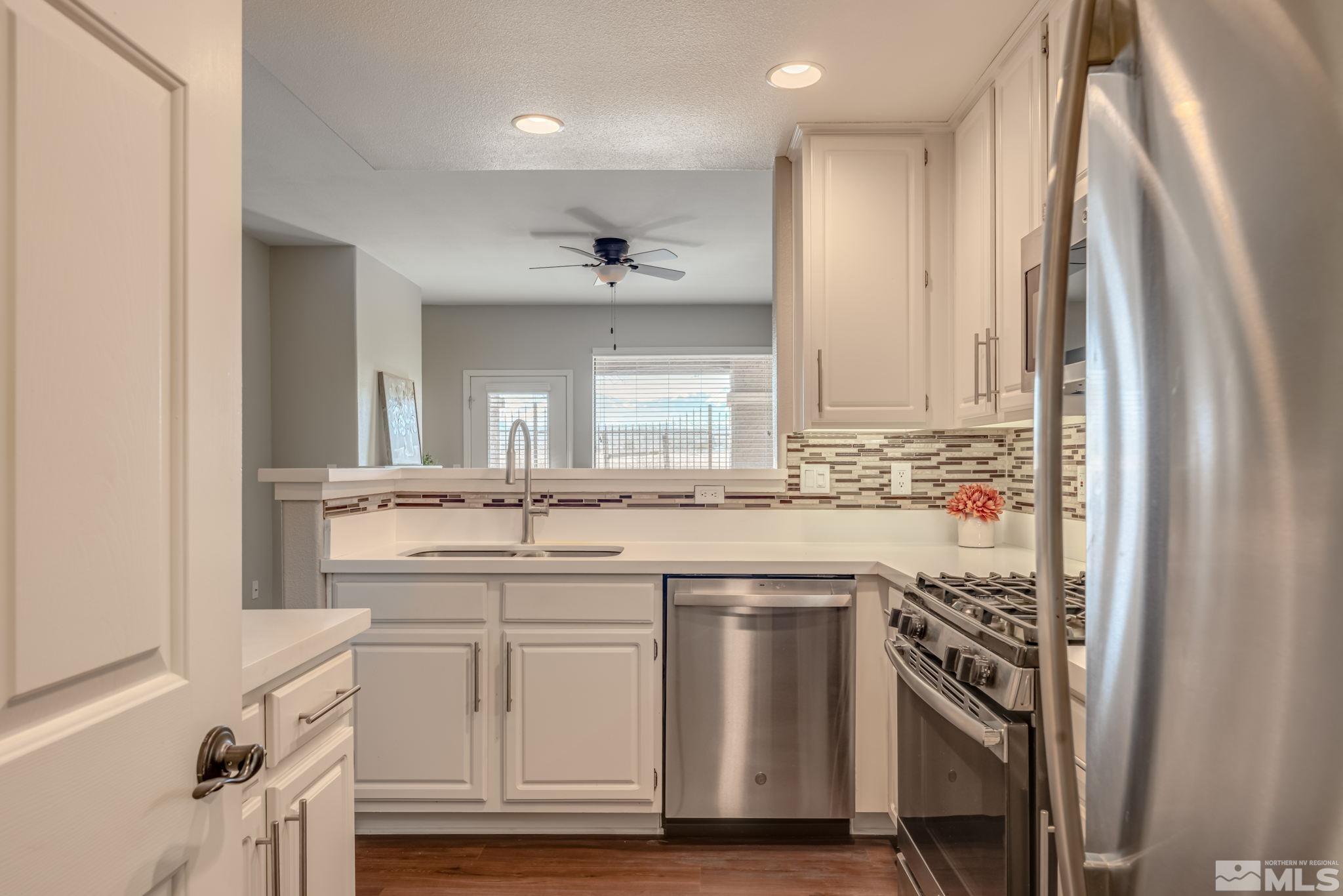 900 S Meadows, Unit 5313 Reno, NV 89521 - Photo 9 of 29 a kitchen with stainless steel appliances granite countertop a sink and cabinets