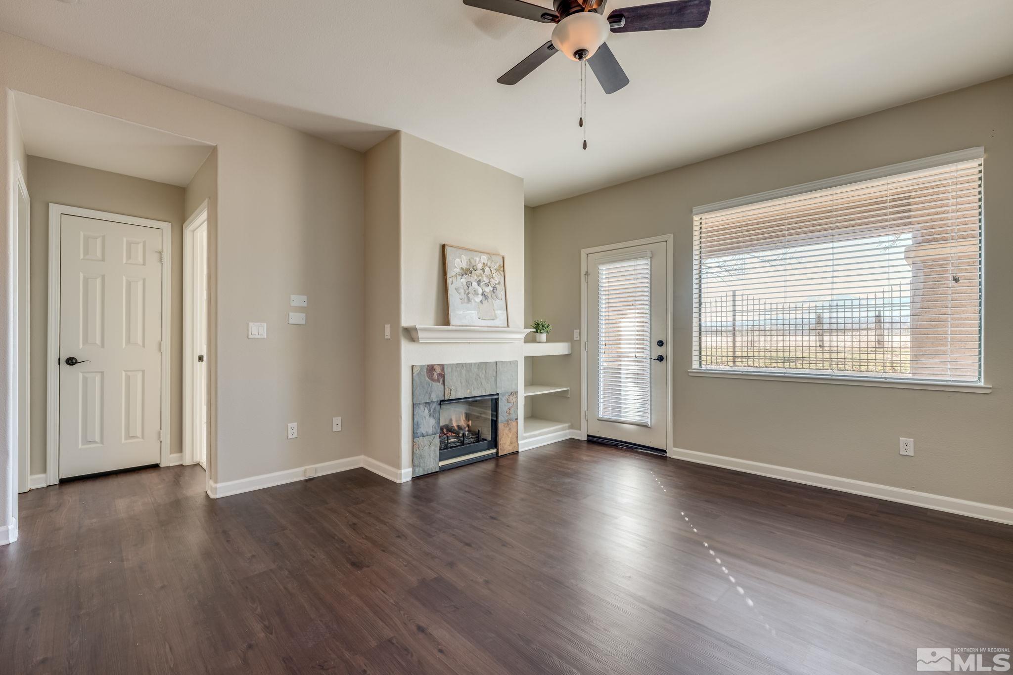 900 S Meadows, Unit 5313 Reno, NV 89521 - Photo 10 of 29 an empty room with wooden floor chandelier and windows