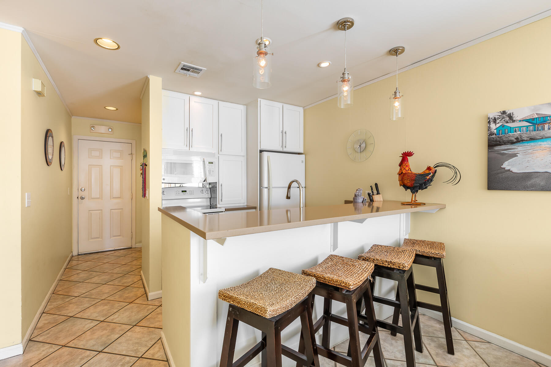 620 Thomas Street, Unit 175 Key West, FL 33040 - Photo 11 of 30 a kitchen with stainless steel appliances kitchen island granite countertop a table and chairs in it