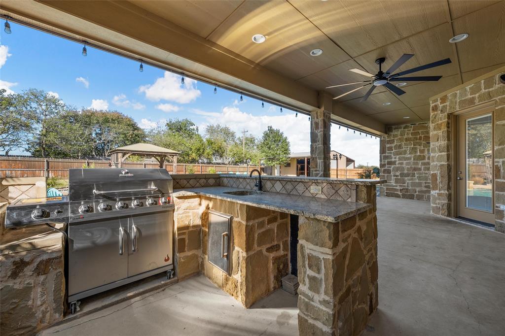 404 Casa Del Rancho Road Lorena, TX 76655 - Photo 21 of 36 a kitchen with stainless steel appliances granite countertop a stove and a refrigerator