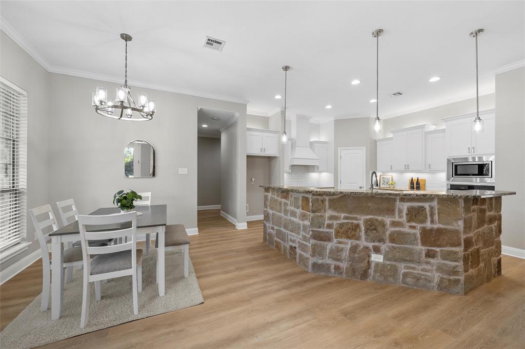 404 Casa Del Rancho Road Lorena, TX 76655 - Photo 5 of 36 a view of a dining room with furniture wooden floor and chandelier