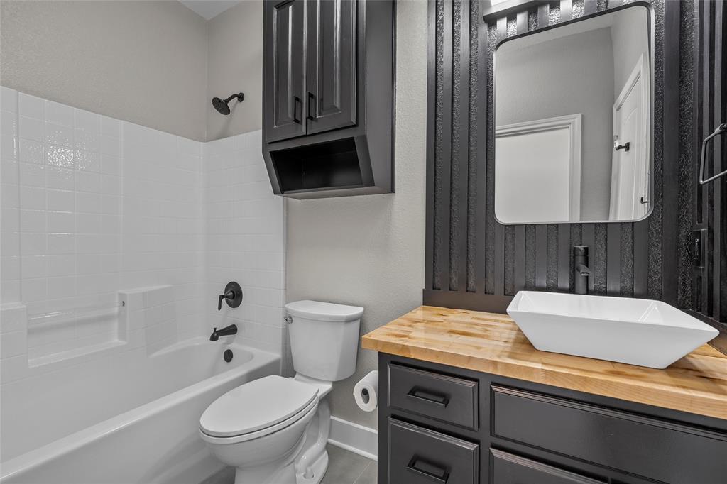 404 Casa Del Rancho Road Lorena, TX 76655 - Photo 9 of 36 a bathroom with a granite countertop toilet sink and mirror