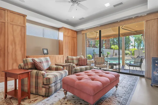 a bedroom with furniture and a large window