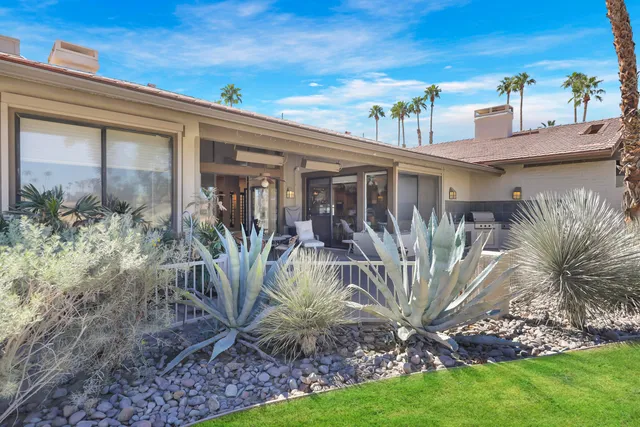 a view of yard with swimming pool and trees