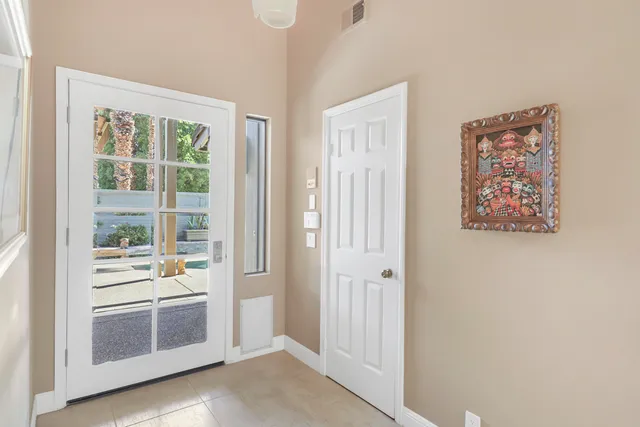 a view of a hallway with wooden floor and cabinet