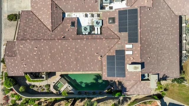 an aerial view of a house with a garden and mountain view