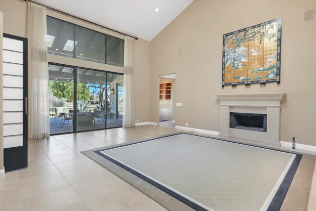 a view of an empty room with a fireplace and a large window