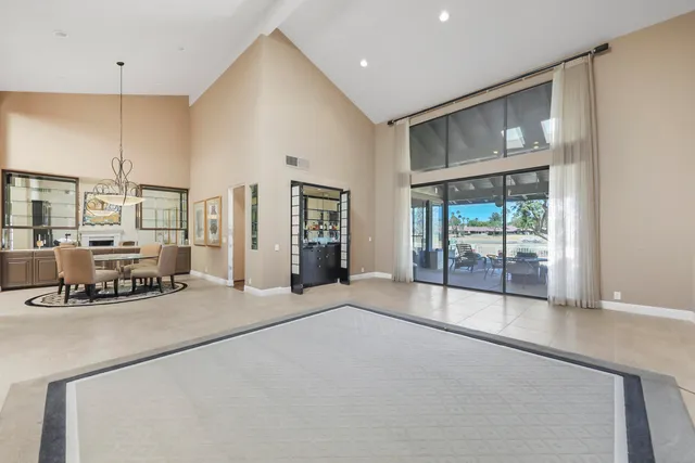 a living room with large window and furniture