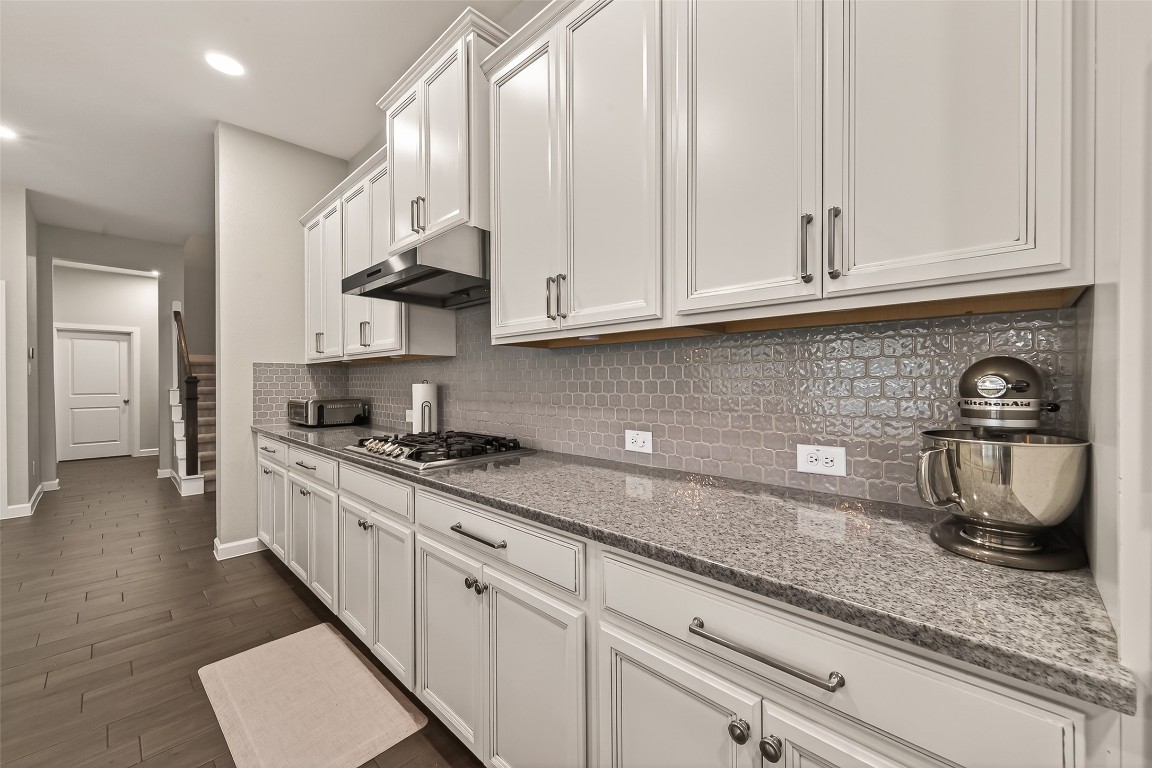 2706 Ripe Amber Cup Court Richmond, TX 77406 - Photo 15 of 50 a kitchen with stainless steel appliances granite countertop a sink a stove and cabinets
