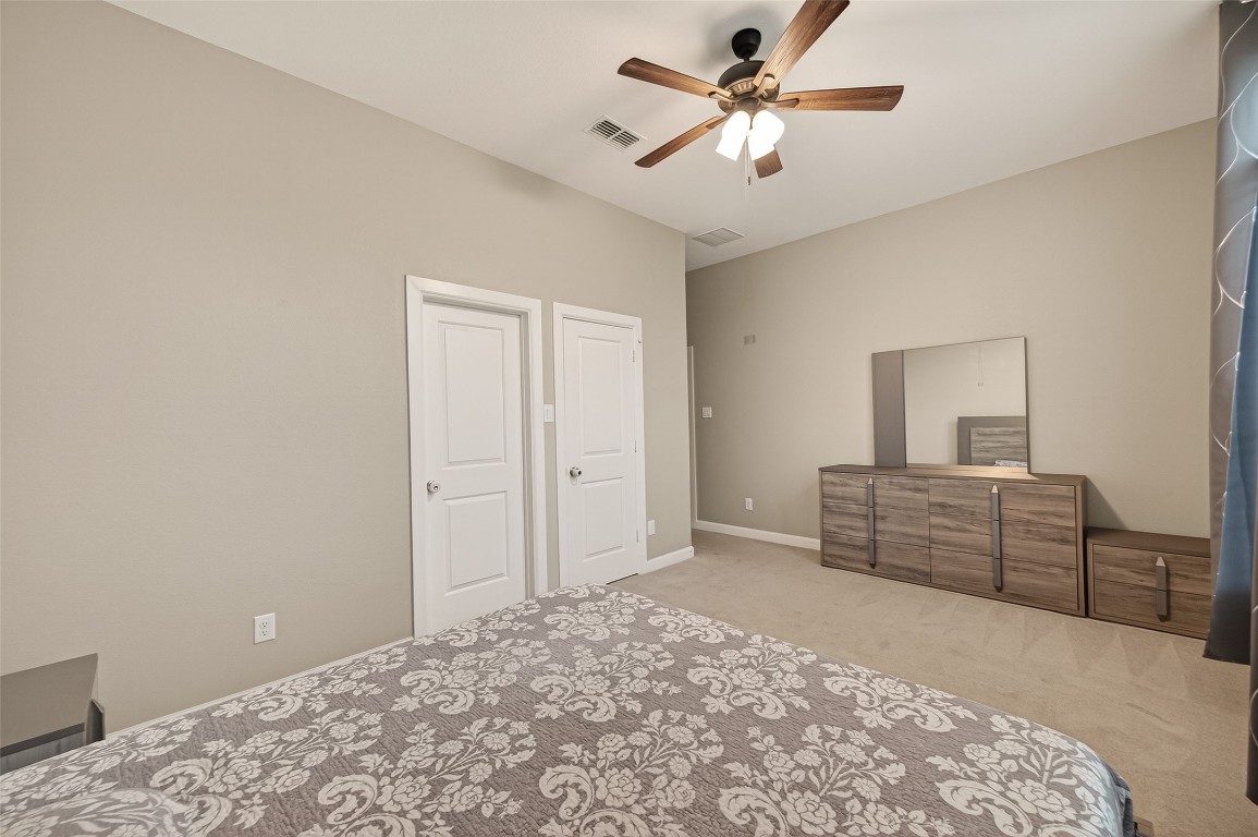 2706 Ripe Amber Cup Court Richmond, TX 77406 - Photo 26 of 50 a bedroom with a bed and a dresser