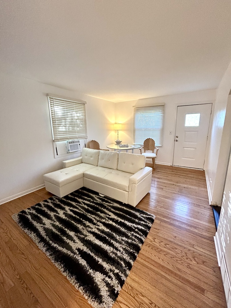 905 Rockland Road Lake Bluff, IL 60044 - Photo 14 of 16 a living room with a bed and a rug