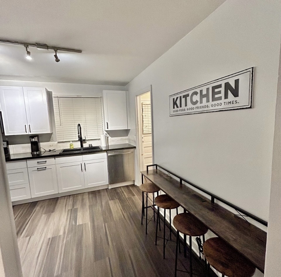 905 Rockland Road Lake Bluff, IL 60044 - Photo 4 of 16 a kitchen with cabinets wooden floor and stainless steel appliances
