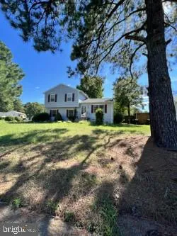 a view of house with yard
