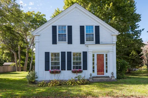 a front view of house with yard and green space
