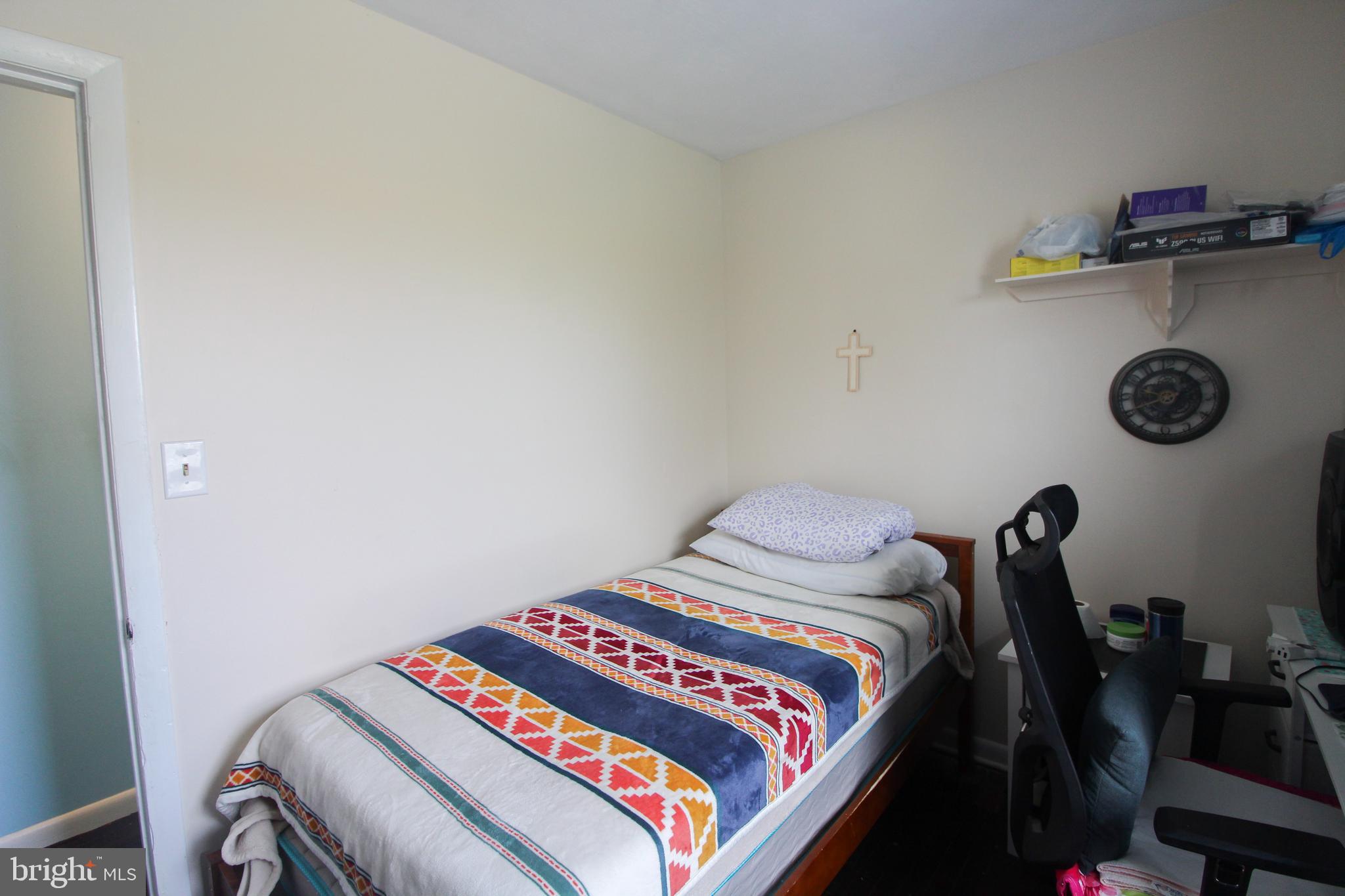 2212 Swartz Road Woodstock, VA 22664 - Photo 15 of 21 a bedroom with a bed and a chandelier