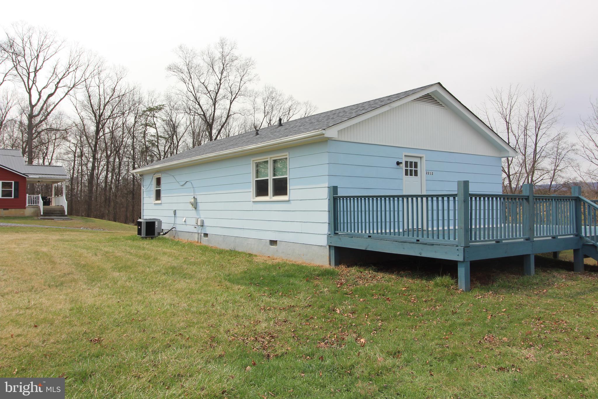 2212 Swartz Road Woodstock, VA 22664 - Photo 4 of 21 a view of a backyard with a garden and deck