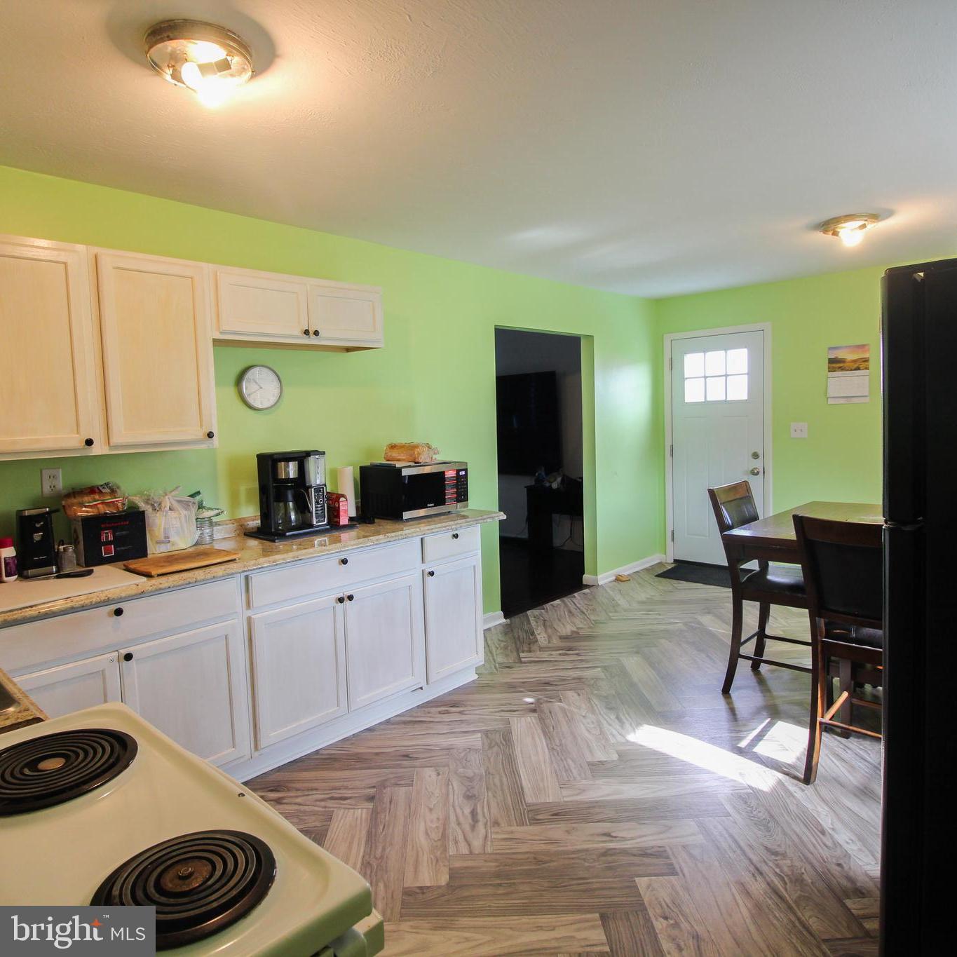 2212 Swartz Road Woodstock, VA 22664 - Photo 10 of 21 a kitchen with a refrigerator and a stove top oven