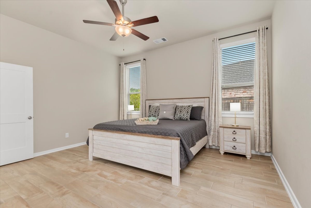 17814 Tree Of Heaven Conroe, TX 77385 - Photo 15 of 48 Spacious primary suite featuring tile flooring, abundant natural light, and a functional layout—offering a comfortable and private retreat.