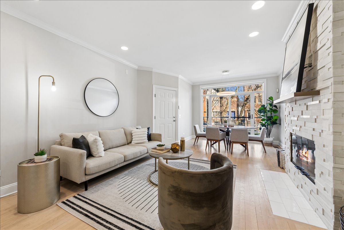 2838 North Damen Avenue, Unit 1 Chicago, IL 60618 - Photo 3 of 25 a living room with fireplace furniture and a large window