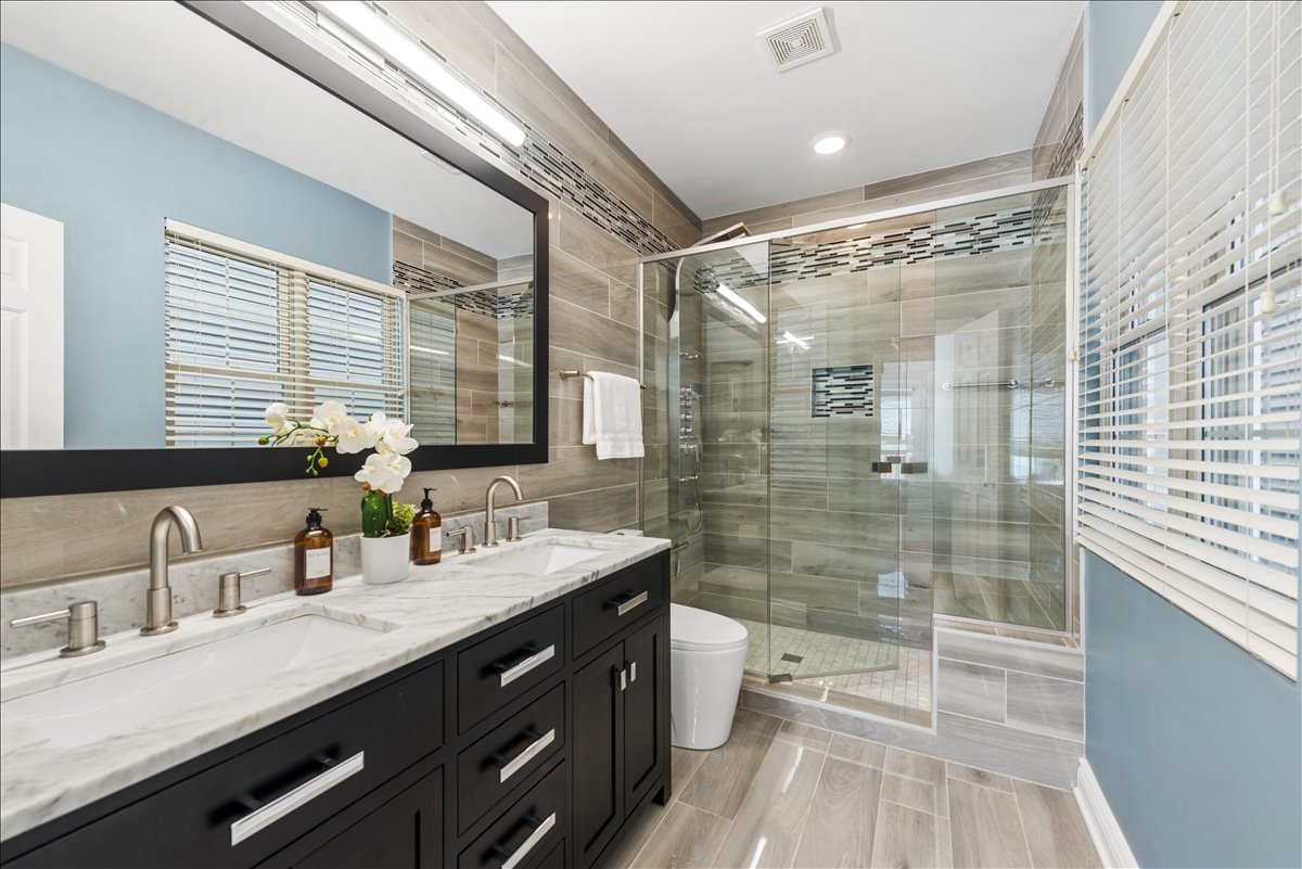 2838 North Damen Avenue, Unit 1 Chicago, IL 60618 - Photo 10 of 25 a bathroom with a double vanity sink toilet and shower