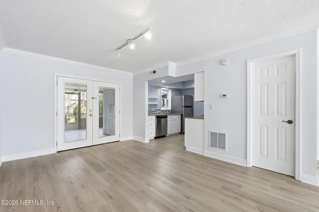 a view of a kitchen with a sink and a refrigerator
