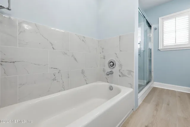 a bathroom with a bathtub and shower