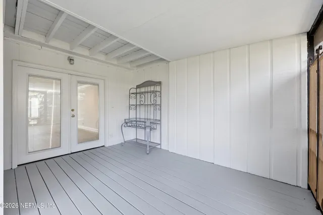 a view of wooden floor and windows in a room