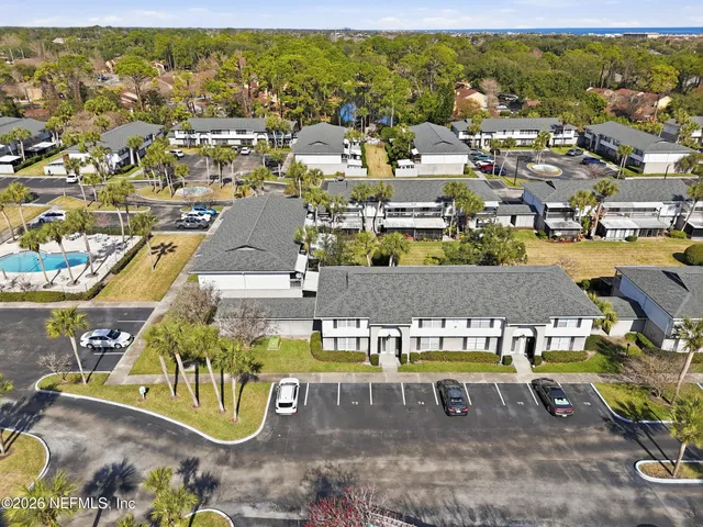 an aerial view of residential houses with outdoor space
