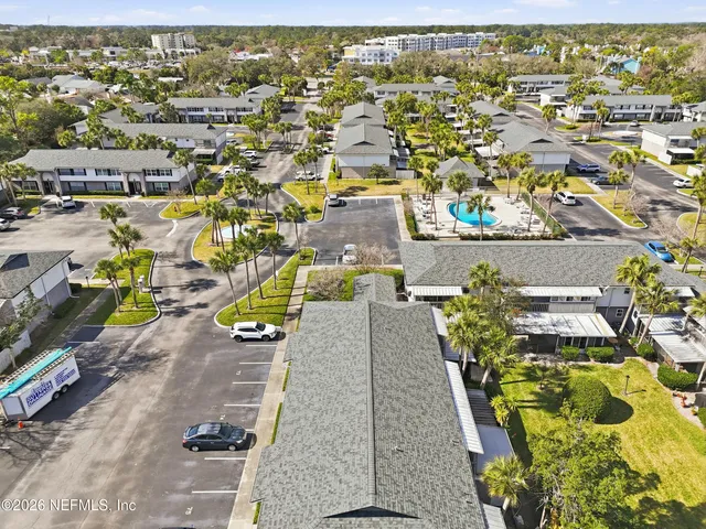 an aerial view of residential houses with outdoor space